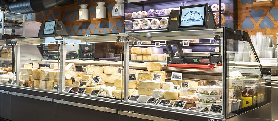 Well-stocked cheese counter in the Dobbiaco shop