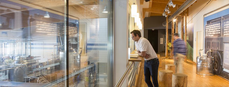 A visitor watching the production through the glass wall