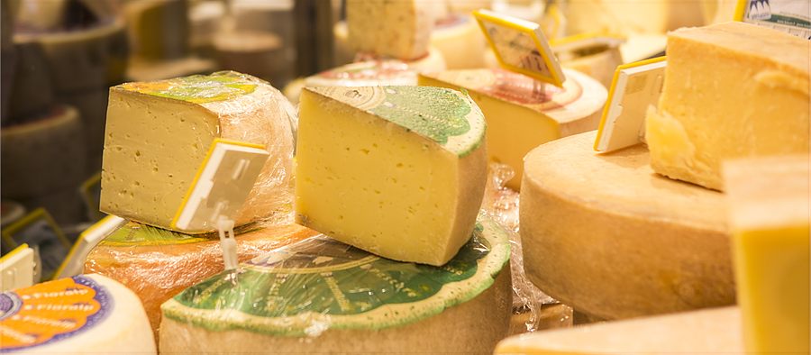 Cheese wheels and cut pieces at the Drei Zinnen Dairy counter