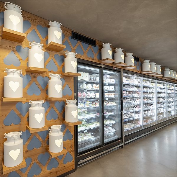 Milk churns as wall decoration in the shop