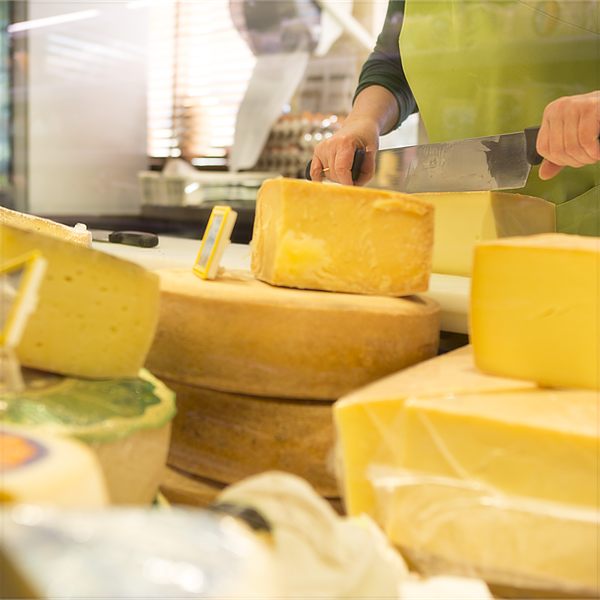 Cheese being cut at the counter