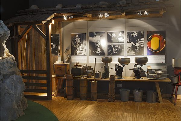 Museum room: butter churns and historic photographs of the handwork