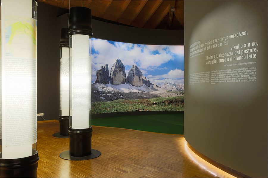 A lit column in front of the Three Peaks panorama in the exhibition room